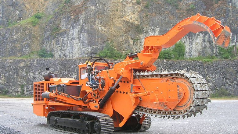 A Trencher Drills Into The Ground, Breaks Up Soil And Rocks, And Removes Debris